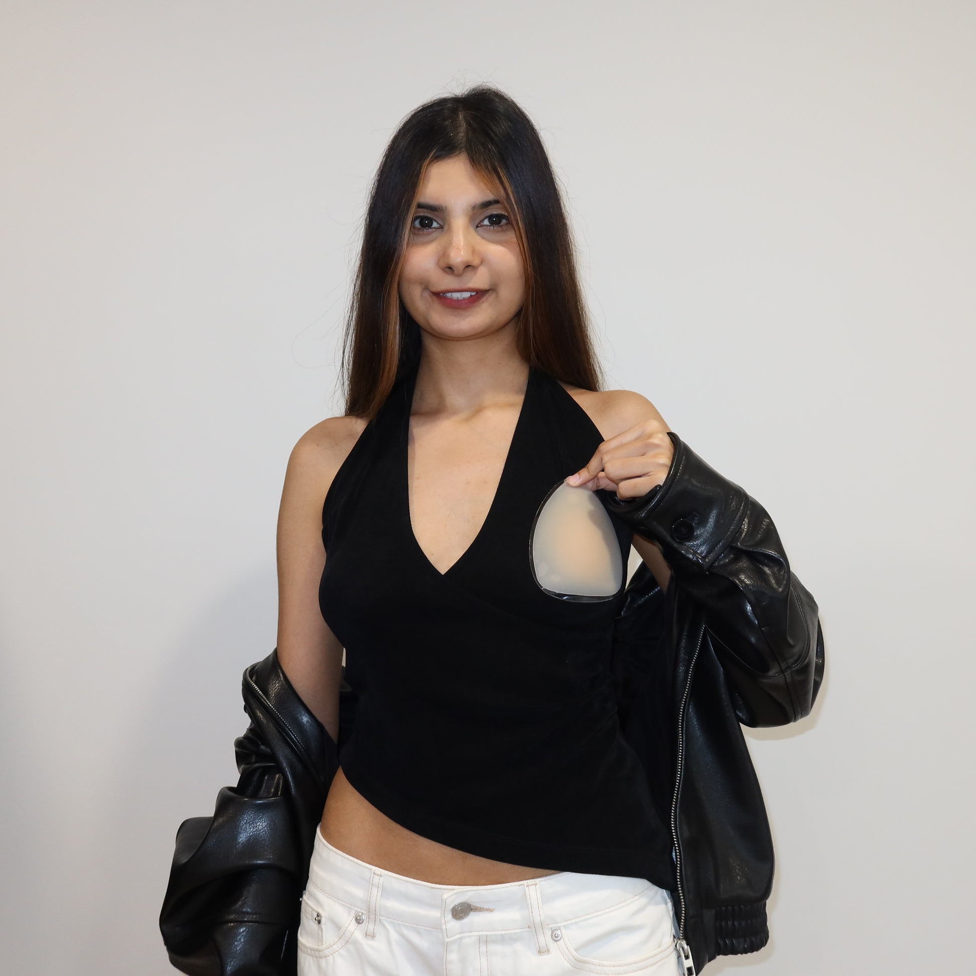 girl holding nip stories triangle nipple covers over deep v neck top