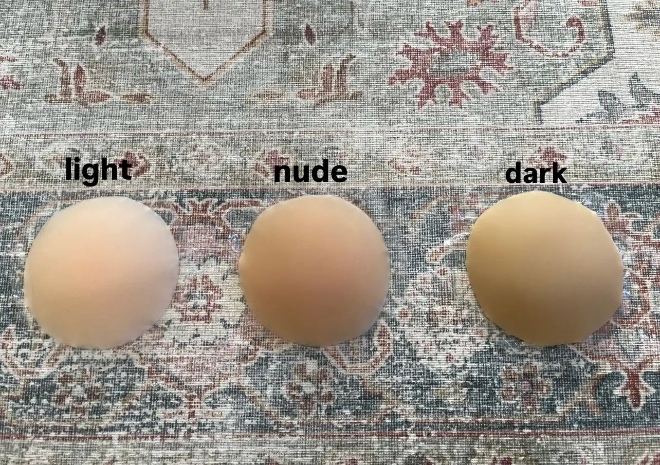 nip stories nipple covers colour comparison photo showing light, nude and dark coloured nipple covers on a carpet background